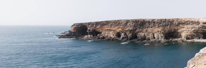 Stunning coastal cliffs of Fuerteventura Island during a calm afternoon