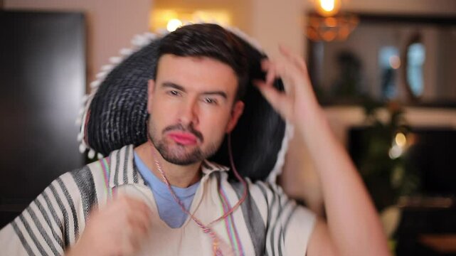 Man wearing a black sombrero and a colorful poncho 