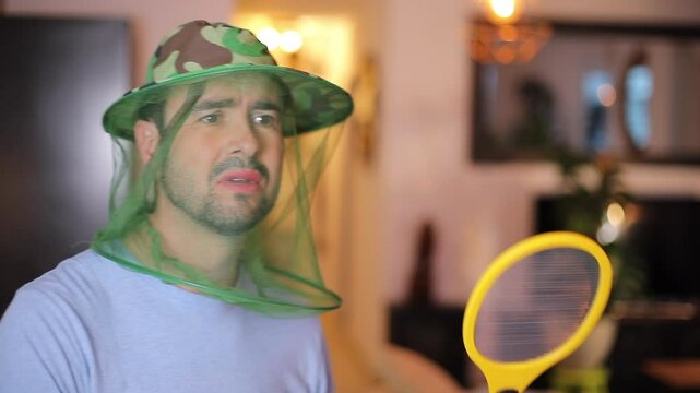 Stressed out man with too many mosquitos at home 