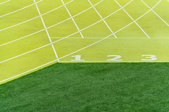 Vibrant view of numbered start lines at an outdoor athletics stadium