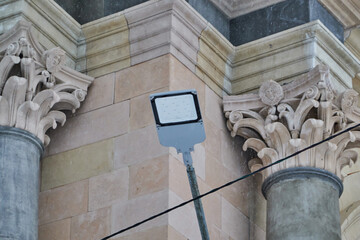 white modern led electric lighting street lamp on city building wall background on clear sunny...