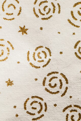 gold glitter swirls and stars on paper