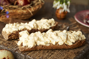 Bread spread made of leftover Easter eggs and sour cream on slices of bread