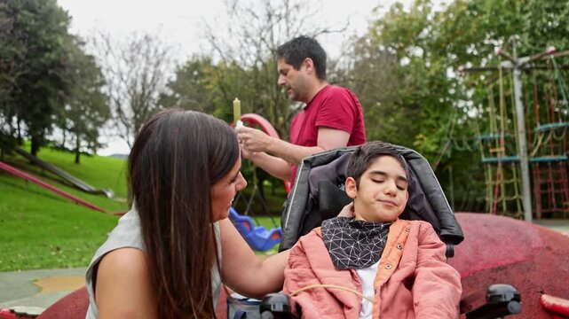 Parents using enteral feeding syringe for son with cerebral palsy