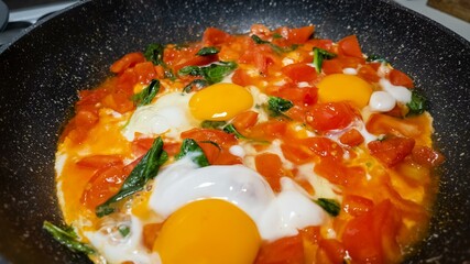 Freshly cooked shakshuka in a skillet, featuring vibrant tomatoes and eggs, perfect for healthy Mediterranean breakfast or brunch, colorful traditional Middle Eastern cuisine