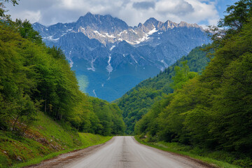 There is a dirt road going through a mountain valley
