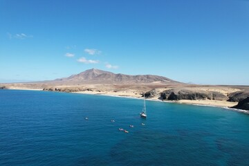 Obraz premium Aerial panorama of LANZAROTE coastline with beaches and volcanic mountains near National Park area of Canary Islands near Playa Blanca