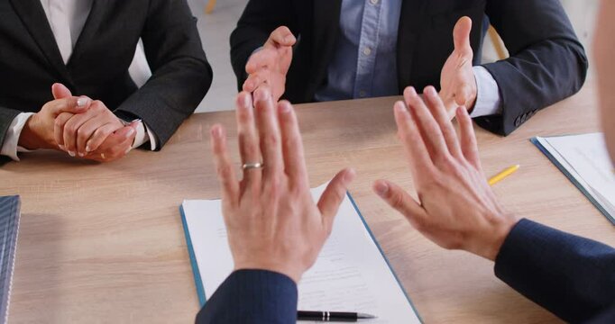 Cropped of two business people man and woman disputing with manager dissatisfied with contract conditions. Angry frustrated couple arguing on meeting in office while agent trying to calm them down.