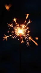 Single burning sparkler against black, leaving bright trails, new year, fire