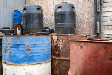 Rusty and Weathered Barrels in Industrial Storage Area.