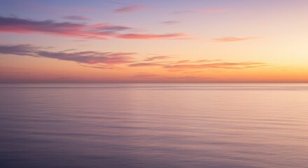 Obraz premium Calm Ocean at Sunset with Soft Pastel Clouds and Water
