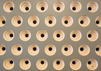 Geometric pattern of round wooden structures in club wall