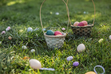 Easter egg hunt with colorful baskets in grassy field
