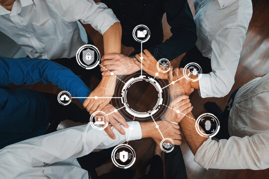 Business team joining hand in circular together symbolize successful group of business partnership and strong collective unity teamwork in community workplace. Prudent Amity