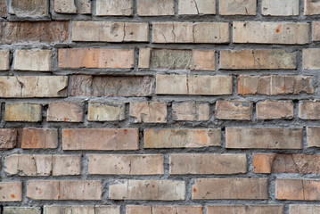 Old brick wall with cracked mortar