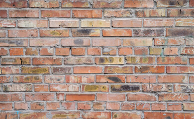 Worn brick wall with yellow and red hues