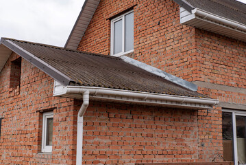 Old gutter system on the corner of a brick house