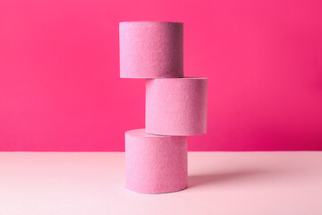 Color toilet paper rolls on pink background