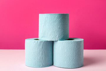 Blue toilet paper rolls on pink background