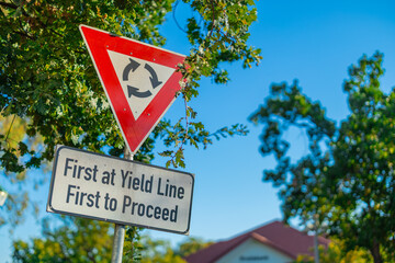 Sign for the right of way in south african roundabouts, which work in a manner of first come first serve. Traffic sign to indicate drivers who goes first