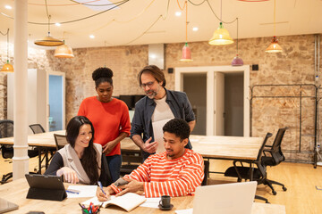 Collaborative team working in modern coworking space