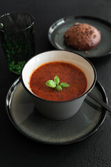 Bowl of homemade red bean soup on dark wooden table. Front view