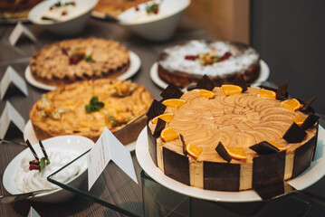 Orange--Chocolate Cake and other desserts on a large table.