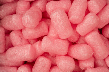 Pink and white box filler as a background. Top view.