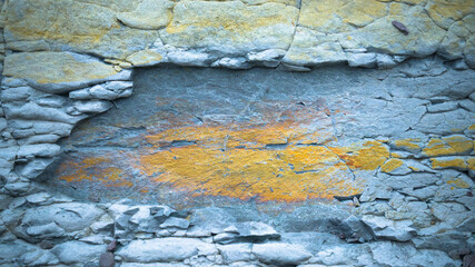 Close-up of a textured rock surface with layers of cracked stone. 