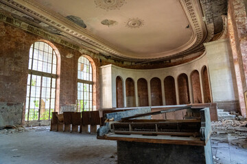 Eerie Beauty of an Abandoned Grand Hall
A decayed, once-grand room with arched windows, an ornate...