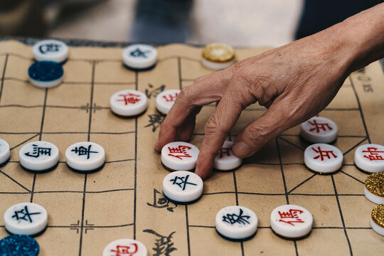 Senior hand playing traditional Chinese game Xiangqi in Hong Kong