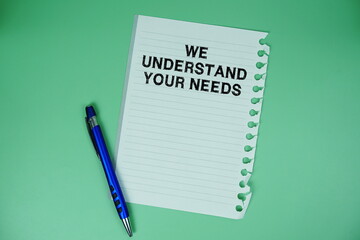 We Understand Your Needs text written on paper with pen on green background