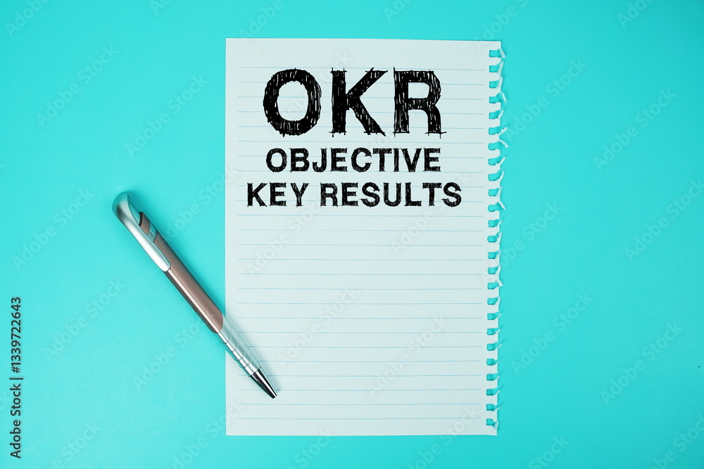 Poster okr objective key results text written on paper with pen flat lay on blue background