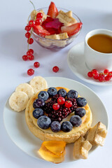 Delicious Breakfast with Toast Berries and Chocolate Cookies on a Light Background