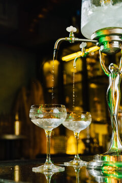 Absinthe and Ice Water Filtered into Crystal Glassware
