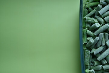 frozen Asparagus beans cut, macro green beans, green frozen asparagus beans as background photo from above 