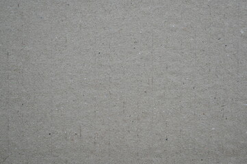 grey kraft paper texture background. Natural brown cardboard surface with fine fibers and recycled material look. Eco-friendly packaging and design concept.