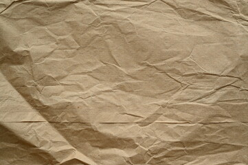 Obraz premium brown crumpled paper texture as background, old kraft paper as background, crumpled packing material texture as background photo above