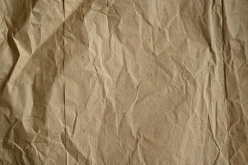 brown crumpled paper texture as background, old kraft paper as background, crumpled packing material texture as background photo above