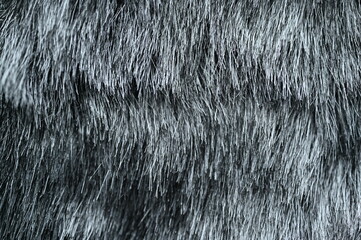 texture of dense grey fur with soft, fluffy fibers. The detailed surface creates a warm and cozy background suitable for fashion, textiles, winter themes, and natural material concepts.