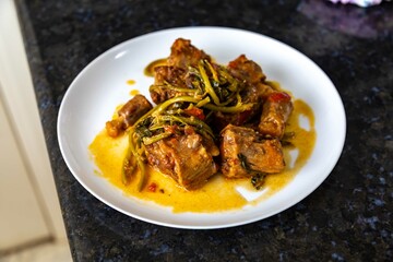 Traditional beef oxtail with watercress, a rustic Brazilian dish