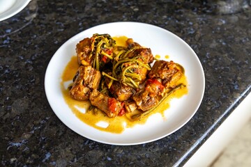 Traditional beef oxtail with watercress, a rustic Brazilian dish