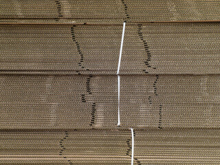 Stacked corrugated cardboard boxes background, close up view