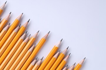 Many pencils on light grey background, top view. Space for text