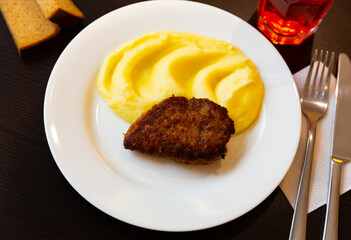 Closeup of traditional ukrainian cutlet with potato puree, served with bread and compote