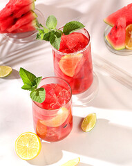 Detox diet and summer party concept. Cold homemade lemonade or cocktail with mint, watermelon and...
