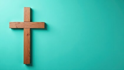 Simple wooden cross on faded teal painted wall, christian, detail, decor