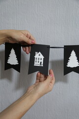 hand holding dark black flag garland.