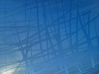 There is frost on the window against the blue sky. Icy background, frozen surface.