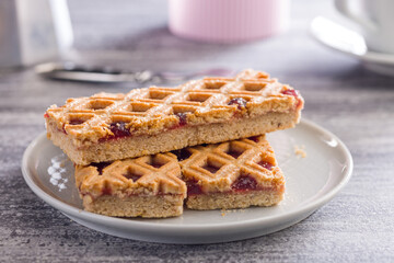 Sweet linzer cake on plate on kitchen table.